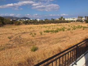 a field of grass next to a fence at El Sueno in Lachi