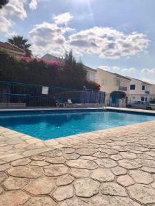 a swimming pool with blue water in a yard at El Sueno in Lachi