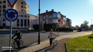 a man and a woman riding bikes on a street at UNIQUE LOCATION APARTMENT WITH PARKING in Burgas City