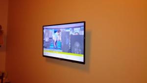 a flat screen tv hanging on a wall at Plena Vita RESIDENCE in Loures