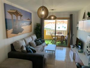 a living room with a couch and a table at Maria Perla Medano in El Médano