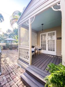 a front porch of a house with a wooden deck at Authors Key West Guesthouse in Key West