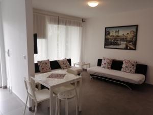 a living room with a couch and a table at Apartment EG in Oststeinbek