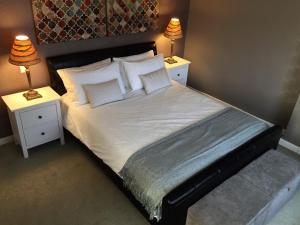 a bedroom with a large bed with two night stands at Hillview in Ballater