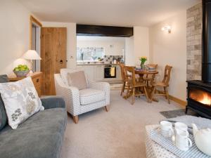 a living room with a couch and a fireplace at Chatton Cottage in Chatton