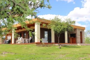 a small house with a green lawn in front of it at La Encantada in Potrero de los Funes