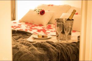 a bed with a table with a bottle of wine and a glass at Piso Paseo Marítimo in Benalmádena +28 photos