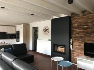 a living room with a couch and a fireplace at La maison du pêcheur Koksijde in Koksijde