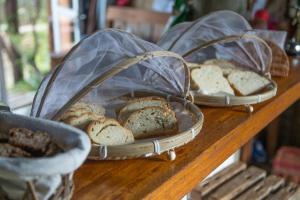 three baskets of bread on a wooden table at Lo De Ro in Barra de Valizas