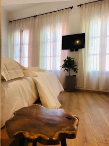 um quarto com uma cama, uma televisão e uma mesa em Foleza - Bed and breakfast em Vlorë