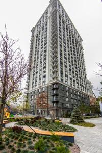 a tall white building with a courtyard in front of it at Стильные апартаменты,метро Вырлица,метро Харьковская in Kyiv