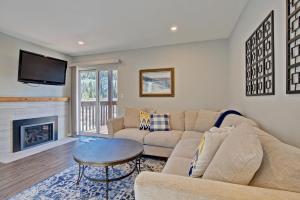 a living room with a couch and a fireplace at Mountainside #272H in Frisco