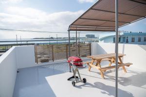 a picnic table and bench on the roof of a boat at ホテルトーマスみなみ in Itoman