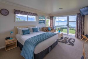 a bedroom with a large bed and a large window at Bendamere House Bed & Breakfast in Kaikoura