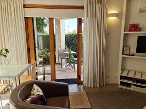 a living room with a couch and a table at Parnell Garden Suite in Auckland