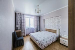 チタにあるDekabrist Apartment at Krasnoarmeyskaya 14のベッドルーム1室(ベッド1台、窓、椅子付)