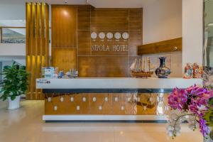 a lobby of a museum with a nederdale hotel sign on the wall at Nipola Hotel - Chợ Đêm Dương Đông Phú Quốc in Phú Quốc