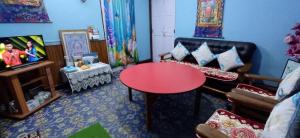 a living room with a couch and a table at Blue Horizon Homestay in Darjeeling