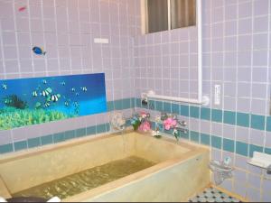 a bath tub in a bathroom with a fish tank at Kamo-gun - Hotel / Vacation STAY 41222 in Okawa