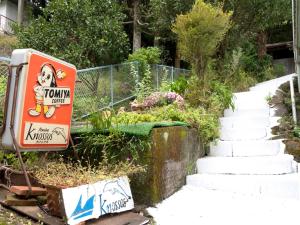 a set of stairs with a sign and some graffiti at Kamo-gun - Hotel / Vacation STAY 41222 in Okawa