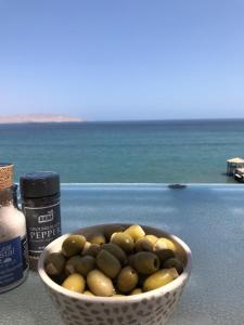 a bowl of olives sitting on a table next to the ocean at Paracas top tower beach front in Paracas