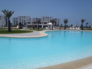 a large swimming pool in front of a building at Paracas top tower beach front in Paracas