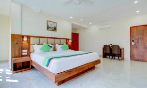a bedroom with a large bed in a room at Treebo The Meridian in Chikmagalūr +39 photos