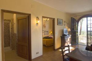 a room with a bedroom with a bed and a door at Poggio d'Oro in San Donato in Poggio