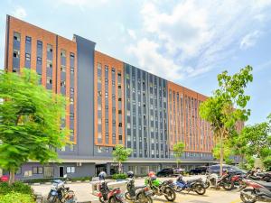 a group of motorcycles parked in front of a building at Collection O 92440 Urban Town Apartment Karawang in Telukjambe