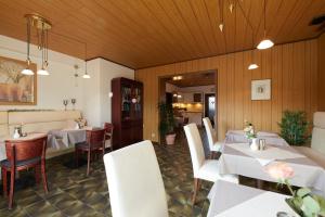 a restaurant with white tables and white chairs at Gisela Bed & Stay Brakel Self Check-In Apartments Business Jakobsweg in Brakel