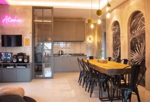 a kitchen and dining room with a wooden table and chairs at Villa Jeje By The Villas 100 in Bogor