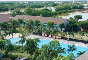 an aerial view of a resort with two pools at Ozon Hotel in Năm Căn