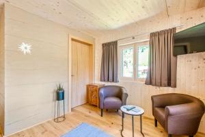 a living room with two chairs and a table at Haus Berghof in Schröcken