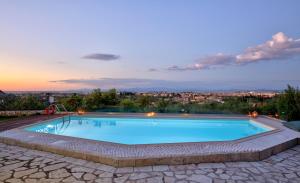 a swimming pool with a view of a city at Alea Resort Villas in Lefkada Town