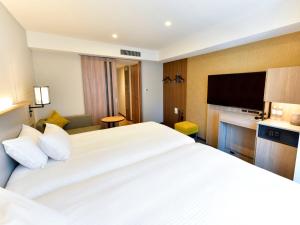 Postel nebo postele na pokoji v ubytování Asakusa Tobu Hotel