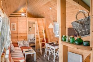 a log cabin with a living room and a bunk bed at Tiny House Lavender in Podtureň