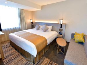 Postel nebo postele na pokoji v ubytování Asakusa Tobu Hotel