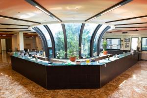 a large room with large windows and a large counter at Hotel Fiera Rho in Rho