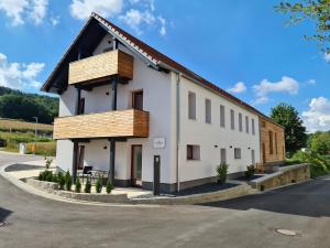 a white building with a black roof at wohnung-nummer-3 in Pielenhofen