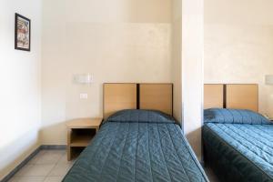 Postel nebo postele na pokoji v ubytování Hotel Fiera Rho