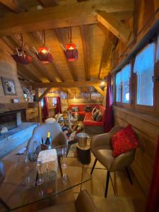 a living room with a table and chairs in a house at Chalet La Grange à Germaine - Propriétés Mont Amour in Avoriaz