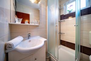 a bathroom with a sink and a shower at Apartments Lazarić in Lopar