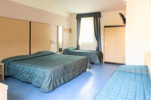 Postel nebo postele na pokoji v ubytování Hotel Fiera Rho