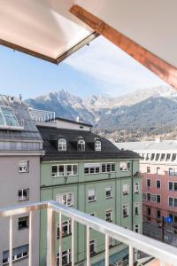 
a large building with a view of a mountain range at Hotel Zach in Innsbruck
