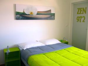 a bedroom with a bed with a flower on the wall at Villa Eden Rock in Schœlcher