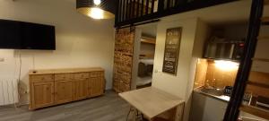 a room with a kitchen with a sink and a counter at Duplex Arc en Ciel - Les Deux Alpes in Mont-de-Lans