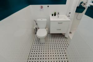 a bathroom with a toilet and a sink at L Ajax Airport Bitwy Warszawskiej in Warsaw