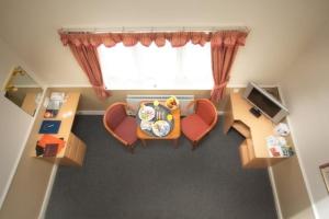 an overhead view of a living room with a table and chairs at Moreton Park Hotel in Chirk