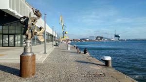 a metal pole on a sidewalk next to a body of water at UNIQUE LOCATION APARTMENT WITH PARKING in Burgas City