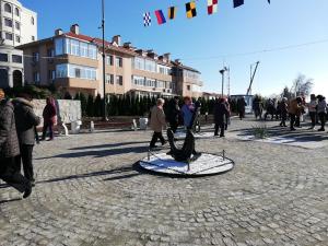 a group of people walking on a street with a kite at UNIQUE LOCATION APARTMENT WITH PARKING in Burgas City
